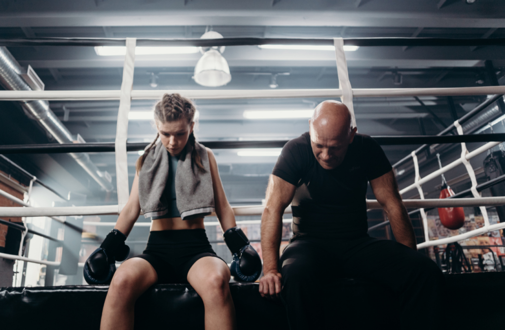 Boxing_Coach and Athlete sitting at boxing ring_ Physical Online fitness courses_NASM