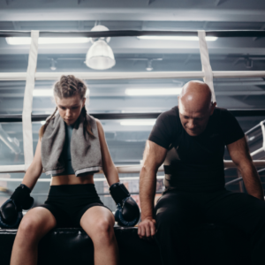 Boxing_Coach and Athlete sitting at boxing ring_ Physical Online fitness courses_NASM
