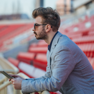 Man standing in a staduim_Physical IQ online fitness courses